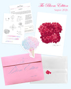 'The Bloom Edition August 2026' arranged on a pale blue background. The edition includes a pink envelope with blue script, a vellum sleeve with floral sticker seal, a pink hydrangea art print, a pastel flower-shaped sticker, and printed studio note