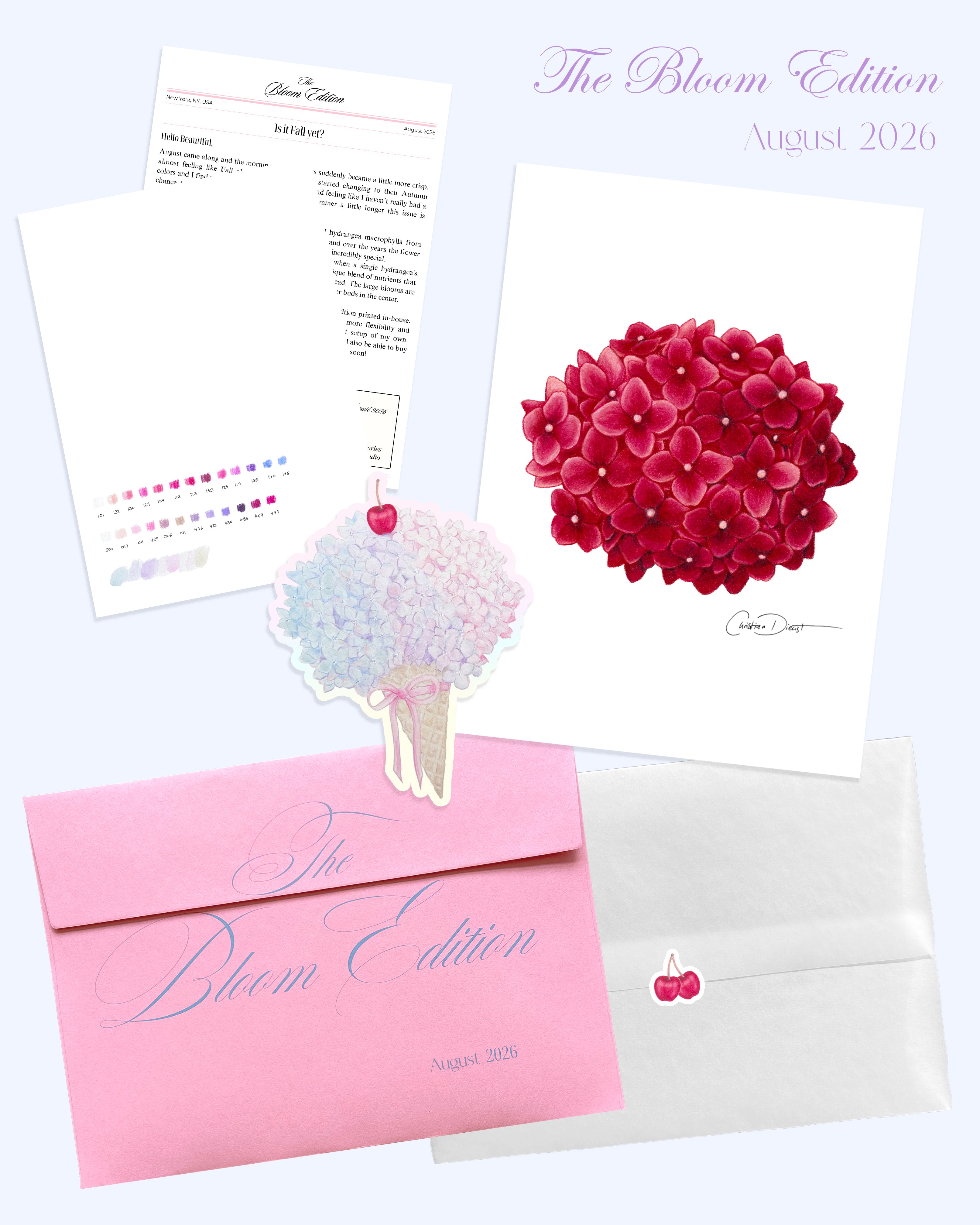 'The Bloom Edition August 2026' arranged on a pale blue background. The edition includes a pink envelope with blue script, a vellum sleeve with cherry sticker seal, a pink hydrangea art print, a pastel flower-shaped sticker, and printed studio note