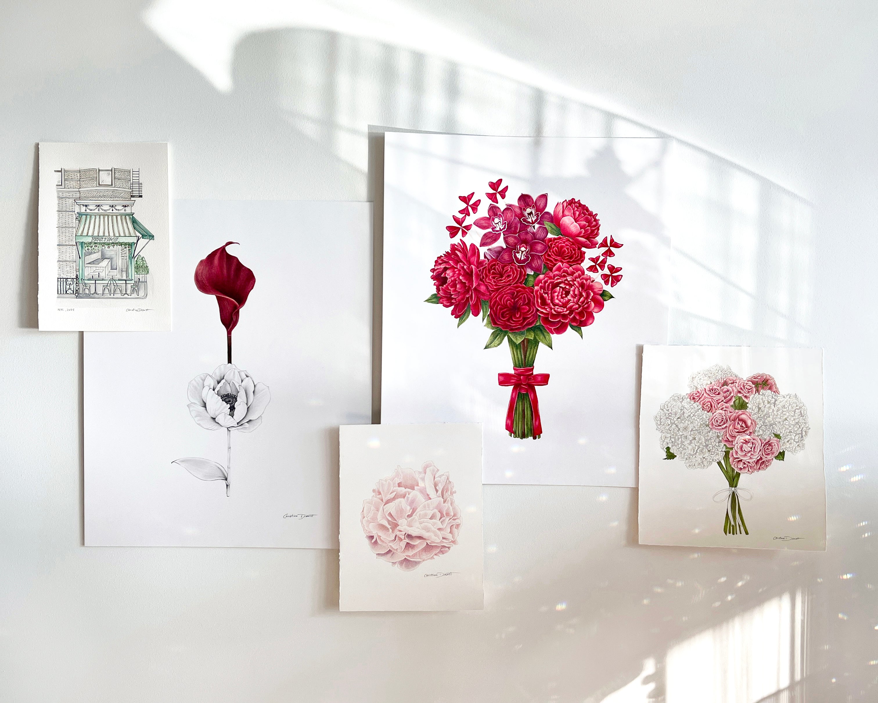 Set of floral art prints on a wall