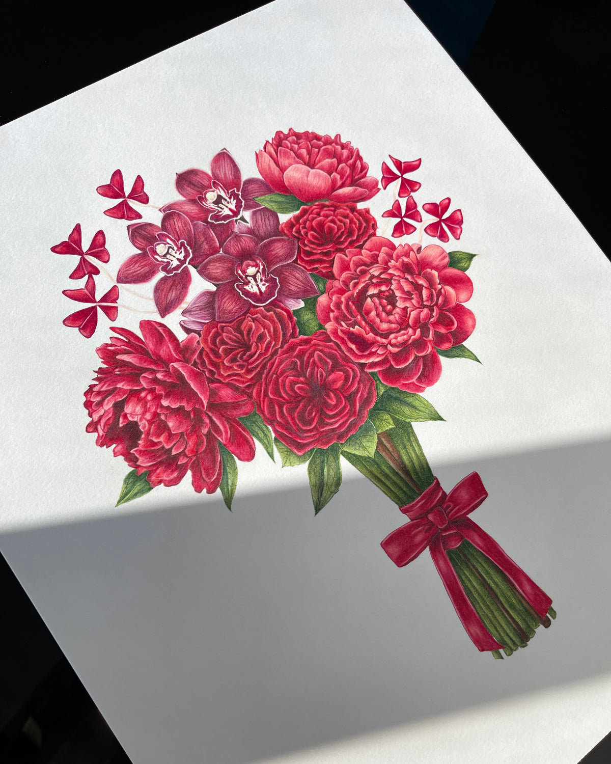 Bouquet of red flowers with a bow on a white background