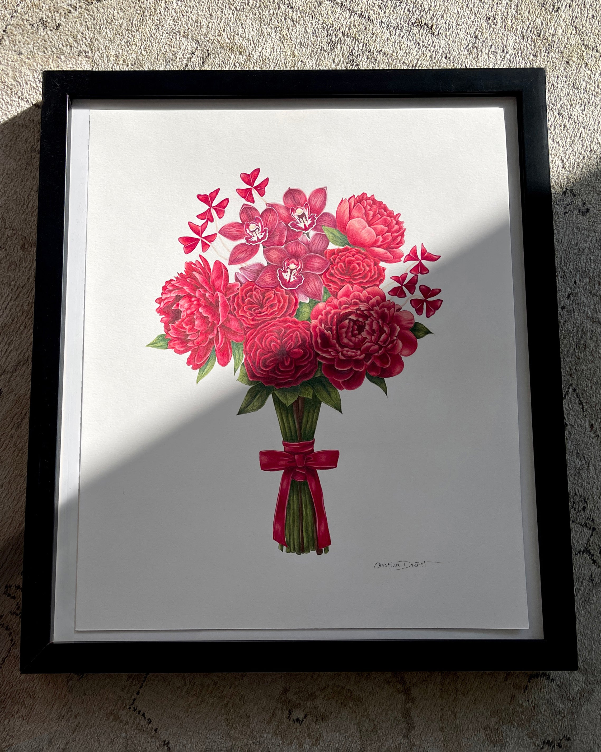 Framed artwork of a bouquet of red flowers on a white background