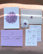Floral-themed print club set including a dahlia art print, sticker and a light purple envelope.