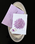 Floral-themed print club set including a dahlia art print, sticker and a light purple envelope.
